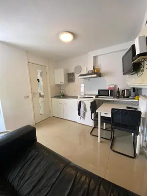 a living room with a table and a kitchen at La Luna - Desi in Heerhugowaard