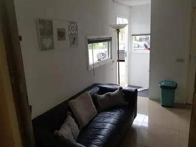 a black leather couch in a living room at La Luna - Desi in Heerhugowaard