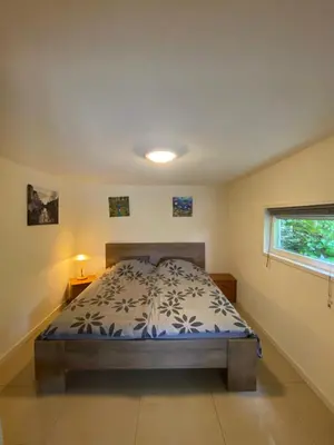a bedroom with a bed and a window at La Luna - Desi in Heerhugowaard