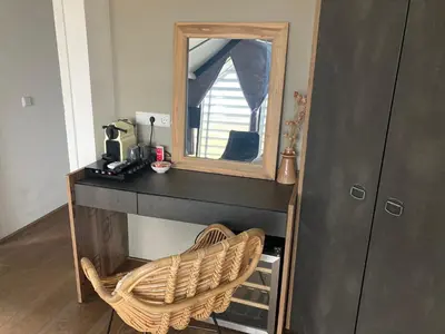 a dressing table with a mirror and a chair at Villa Zandvoort in Zandvoort