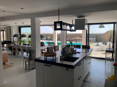 a kitchen and dining room with a view of a pool at Villa Zandvoort in Zandvoort