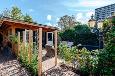 a garden with a gazebo and some plants at Bed and Beach Zandvoort in Zandvoort