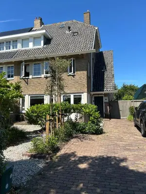 a house with a brick driveway in front of it at Bed and Beach Zandvoort in Zandvoort