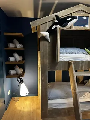 a bunk bed with a stuffed animal on top of it at Waterlinie Lodges in Utrecht