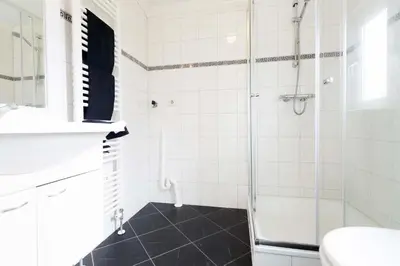 a bathroom with a shower and a toilet and a sink at Park Westerkogge in Berkhout