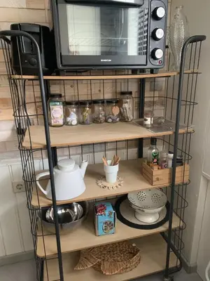 a microwave oven sitting on top of a shelf at Appartement 't Souterrain in Zandvoort