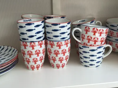 a group of four coffee cups sitting on a shelf at Appartement 't Souterrain in Zandvoort