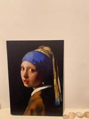 a painting of a woman in a blue headwrap at Appartement 't Souterrain in Zandvoort