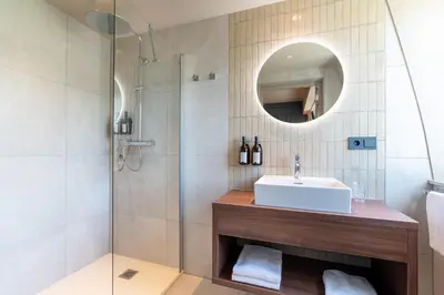 a bathroom with a sink and a shower at Boutique Hotel Malie House in Utrecht