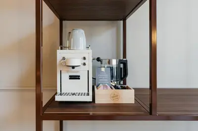 a coffee maker sitting on a wooden shelf at Boutique Hotel Malie House in Utrecht