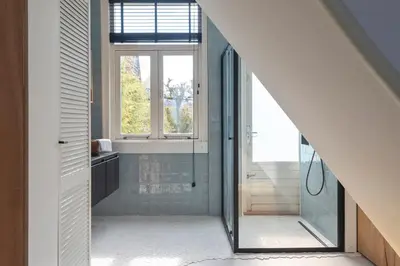 a bathroom with a shower and a mirror at Second Paradise for 2 adults and 2 children in Zandvoort