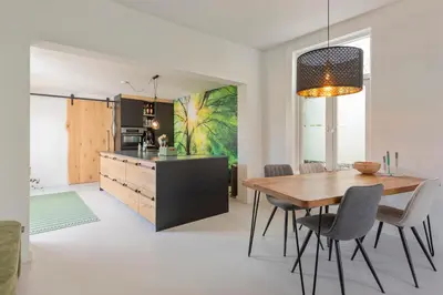 a kitchen and dining room with a table and chairs at Second Paradise for 2 adults and 2 children in Zandvoort