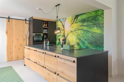 a kitchen with a large painting on the wall at Second Paradise for 2 adults and 2 children in Zandvoort