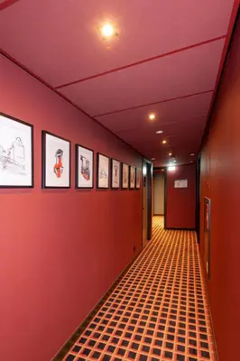 a hallway with red walls and a orange floor at Hotel Nicolaas Witsen in Amsterdam