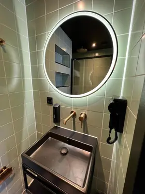 a bathroom with a sink and a mirror at Hotel Nicolaas Witsen in Amsterdam