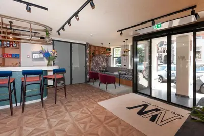 a restaurant with a bar and chairs in a room at Hotel Nicolaas Witsen in Amsterdam