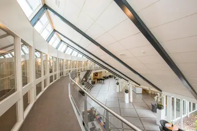 an empty hallway in a building with skylights at Fletcher Hotel - Resort Spaarnwoude in Velsen-Zuid
