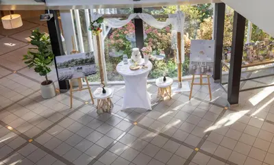 a room with a white table and chairs and a window at Fletcher Hotel - Resort Spaarnwoude in Velsen-Zuid
