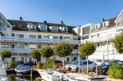 a parking lot with boats in front of a building at Luxury Apartment near Utrecht & Amsterdam in Breukelen
