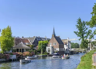 a group of boats on a river in a city at Luxury Apartment near Utrecht & Amsterdam in Breukelen