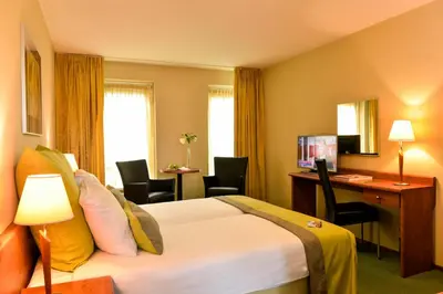a hotel room with a bed and a desk at Hotel Noordzee in Katwijk
