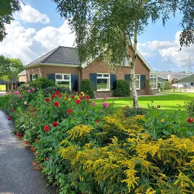 a garden of flowers in front of a house at De Mast bij Fort Vechten on the countryside & close to Utrecht in Bunnik