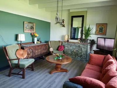 a living room with a couch and a table at De Mast bij Fort Vechten on the countryside & close to Utrecht in Bunnik