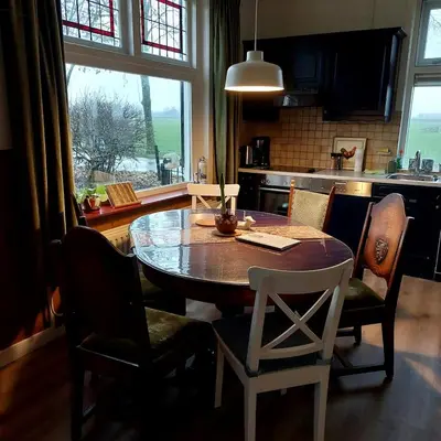 a dining room table and chairs in a kitchen at De Mast bij Fort Vechten on the countryside & close to Utrecht in Bunnik