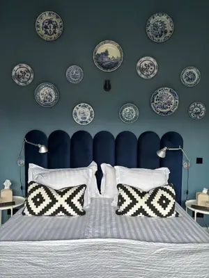 a bedroom with blue and white plates on the wall at Near Amsterdam and airport, 90m2, privacy! in Hoofddorp