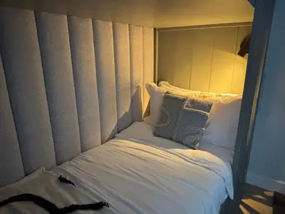 a bed with a headboard and pillows on it at Near Amsterdam and airport, 90m2, privacy! in Hoofddorp