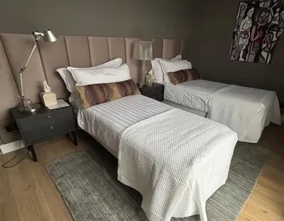 a hotel room with two beds and a lamp at Near Amsterdam and airport, 90m2, privacy! in Hoofddorp