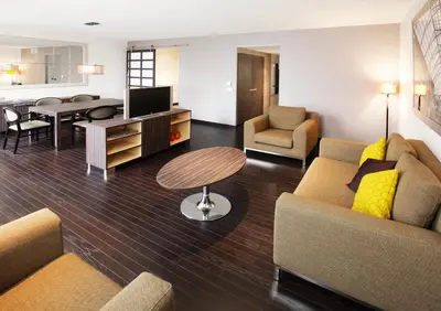 a living room with two couches and a dining room at Krasnapolsky Apartments in Amsterdam