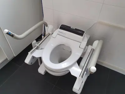 a bathroom with a white toilet in a stall at Aangepast vakantiehuis Sandra mindervaliden in Limmen