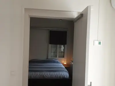a bedroom with a bed in a small room at Aangepast vakantiehuis Sandra mindervaliden in Limmen