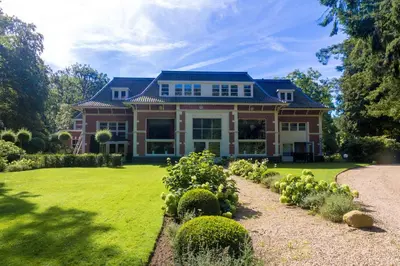 a large house with a garden in front of it at Hotel Ernst Sillem Hoeve in Den Dolder