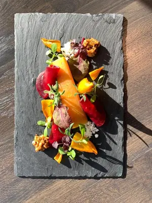a plate of food with fruits and vegetables on a table at Hotel Ernst Sillem Hoeve in Den Dolder
