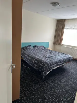 a bedroom with a bed in a room at Cairo in Almere