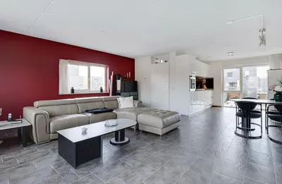 a living room with a couch and a table at Cairo in Almere