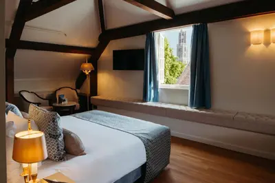 a hotel room with a bed and a window at Grand Hotel Karel V in Utrecht