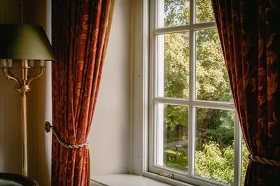 a window with curtains and a lamp in a room at Grand Hotel Karel V in Utrecht