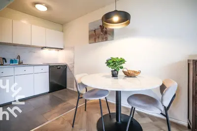 a kitchen with a table and chairs in a room at sunshine in Schoorl