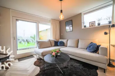 a living room with a couch and a table at sunshine in Schoorl