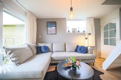 a living room with a couch and a table at sunshine in Schoorl
