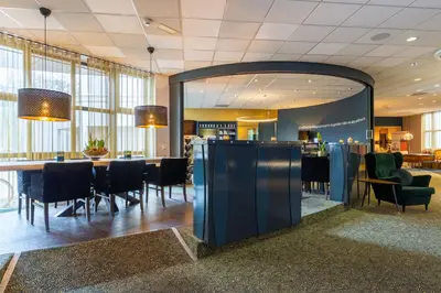 a dining room with a table and chairs at Amrâth Berghotel Amersfoort in Amersfoort