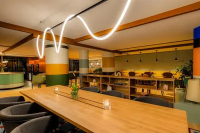 a conference room with a wooden table and chairs at Avani Museum Quarter Amsterdam Hotel in Amsterdam
