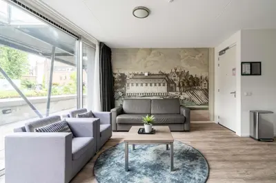 a living room with a couch and a table at YAYS Amsterdam Prince Island by Numa in Amsterdam