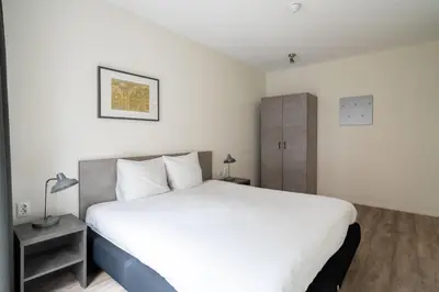 a bedroom with a large white bed in a room at YAYS Amsterdam Prince Island by Numa in Amsterdam