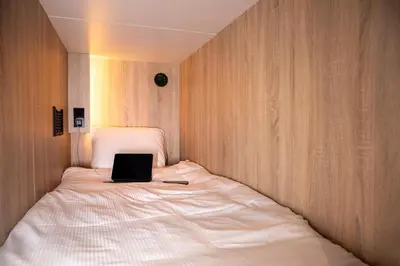 a bed with a laptop sitting on top of it at City Trip Hostels Amsterdam-Zaandam in Zaandam
