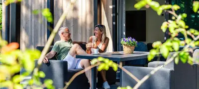 a man and a woman sitting at a table at Résidence Lage Vuursche in Lage-Vuursche