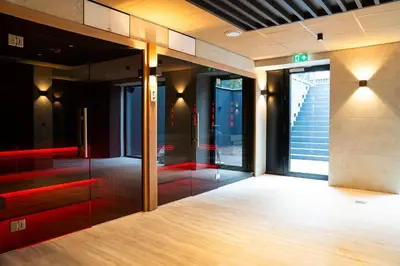 an empty lobby with glass doors and stairs at Résidence Lage Vuursche in Lage-Vuursche